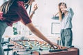 businesswomen playing table football