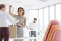 Businesswomen removing tangled cables from box at new office Royalty Free Stock Photo