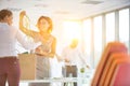 Businesswomen removing tangled cables from box at new office Royalty Free Stock Photo