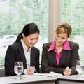Businesswomen reviewing paperwork