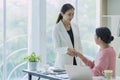 Businesswomen shaking hands as hello in office, women is enjoying with her workmate, Handshake is connection deal concept