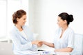 Businesswomen shaking hands in office Royalty Free Stock Photo