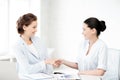 Businesswomen shaking hands in office Royalty Free Stock Photo