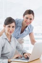 Businesswomen smiling at camera with laptop Royalty Free Stock Photo