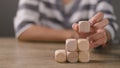 Businesswomen stack blank wooden cubes on the table with copy space, empty wooden cubes for input wording, and an infographic icon