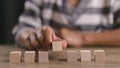 Businesswomen stack blank wooden cubes on the table with copy space, empty wooden cubes for input wording, and an infographic icon