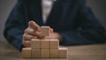 Businesswomen stack blank wooden cubes on the table with copy space, empty wooden cubes for input wording, and an infographic icon