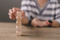 Businesswomen stack blank wooden cubes on the table with copy space, empty wooden cubes for input wording, and an infographic icon