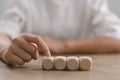 Businesswomen stack blank wooden cubes on the table with copy space, empty wooden cubes for input wording, and an infographic icon Royalty Free Stock Photo