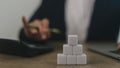 Businesswomen stack blank wooden cubes on the table with copy space, empty wooden cubes for input wording, and an infographic icon Royalty Free Stock Photo