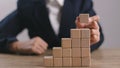 Businesswomen stack blank wooden cubes on the table with copy space, empty wooden cubes for input wording, and an infographic icon