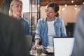 Businesswomen talking with colleagues during an office meeting Royalty Free Stock Photo