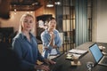 Businesswomen talking with coworkers during an office meeting Royalty Free Stock Photo