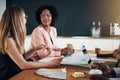 Businesswomen talking together during a meeting in an office boa