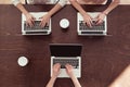 Businesswomen typing on laptops at table Royalty Free Stock Photo