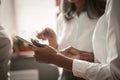 Businesswomen using digital tablet in office. Close up shot of female hands. African American and Asian women wearing Royalty Free Stock Photo