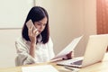 Businesswomen are using the phone to discuss business deals.