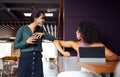 Businesswomen Wearing Masks Have Socially Distanced Meeting In Office Cubicle Royalty Free Stock Photo