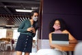 Businesswomen Wearing Masks Having Socially Distanced Meeting In Office