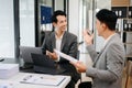 Businesswomen work and discuss their business plans. A Human employee explains and shows her colleague the results paper Royalty Free Stock Photo