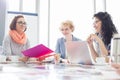 Businesswomen working at desk in creative office