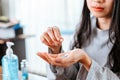 Businesswomen working at home with glass of water takes white round pill in hand