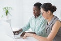 Businesswomen working together at desk