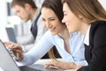 Businesswomen working together with a laptop