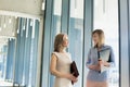 Busineswoman discussing plans while walking in office corridor Royalty Free Stock Photo