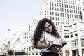 Businnes woman talking on the mobile phone with client and checks the schedule in her notebook Royalty Free Stock Photo