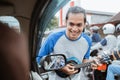 a busker approaches a car window when traffic is jammed