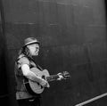 Busker in Dublin playing guitar down a side street