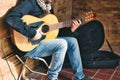 A busker playing Spanish acoustic guitar with a small amplifier in the street Royalty Free Stock Photo