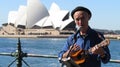 Busker playing ukulele on circular quay