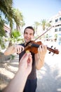 Busker playing violin outside for money Royalty Free Stock Photo