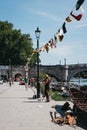 Busker playing violin on the riverbank of the River Thames in Richmond, London, UK.