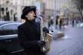 Busker, street musician, playing saxophone on a street Royalty Free Stock Photo