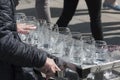 A busker, street performer, musician playing an unusual uncommon instrument made from wine glasses - glass harp Royalty Free Stock Photo