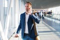 Man talking on phone in airport Royalty Free Stock Photo