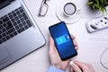 Bussines wooden office desk workplace with blank cellphone, various supplies. It puts the phone on charge .Mock up. Laptop ,hand Royalty Free Stock Photo