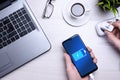 Bussines wooden office desk workplace with blank cellphone, various supplies. It puts the phone on charge .Mock up. Laptop ,hand Royalty Free Stock Photo