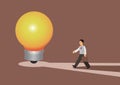 Bussiness man character finding answer walking to huge light bulb