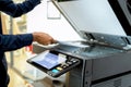 Bussiness man Hand press button on panel of printer, printer scanner laser office Royalty Free Stock Photo