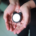 Bussiness woman give a small empty clock on hand