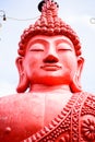 A bust of a pink Buddha