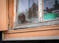 the bust of a poet on the windowsill inside the wooden window