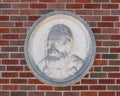 Bust portion of a relief with a Galileo bust and quote on the outside wall of a building at Texas Woman`s University.