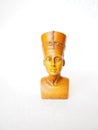 Bust or statue of the ancient Egyptian queen Nefertiti made of brown stone on a white background. The symbol of eternal female Royalty Free Stock Photo