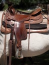 Western leather saddle on a white horse. Royalty Free Stock Photo