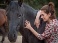 Female giving energy to black andalusian horse. Royalty Free Stock Photo